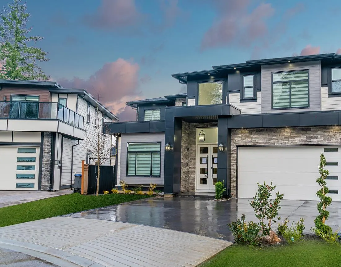 Modern two-storey custom home with stone accents at dusk