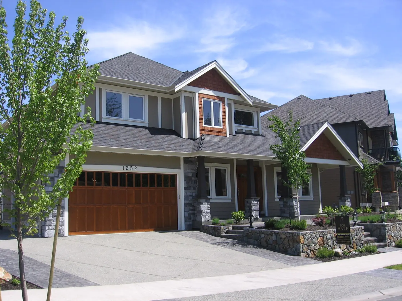 Two completed craftsman-style custom homes on a Greater Victoria street